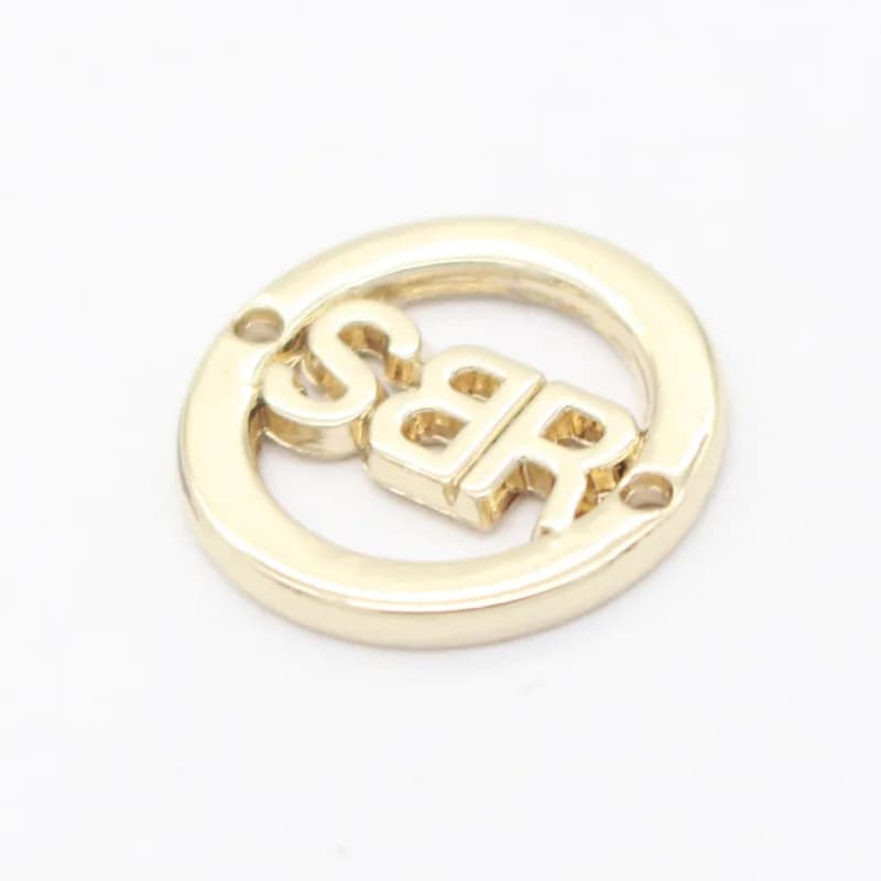 Custom Design Vintage Luxury Trendy Round Hollow Zinc Alloy Labels for Bags and Swim Wear - view 1