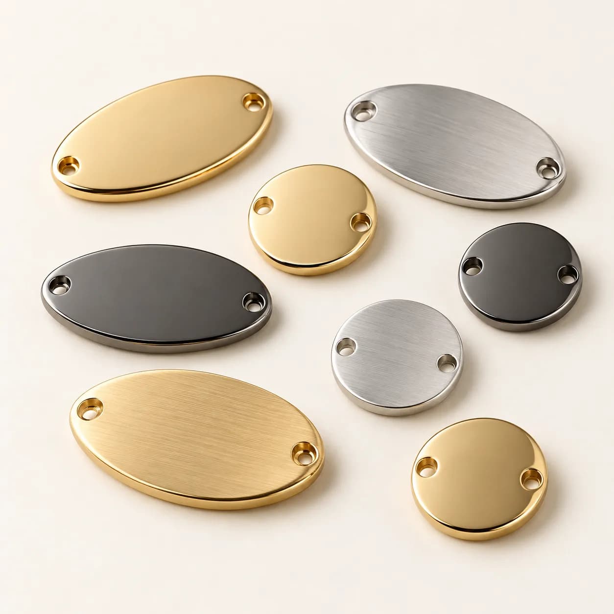 Small sew-on metal badges in gold, silver and gunmetal with discreet attachment holes