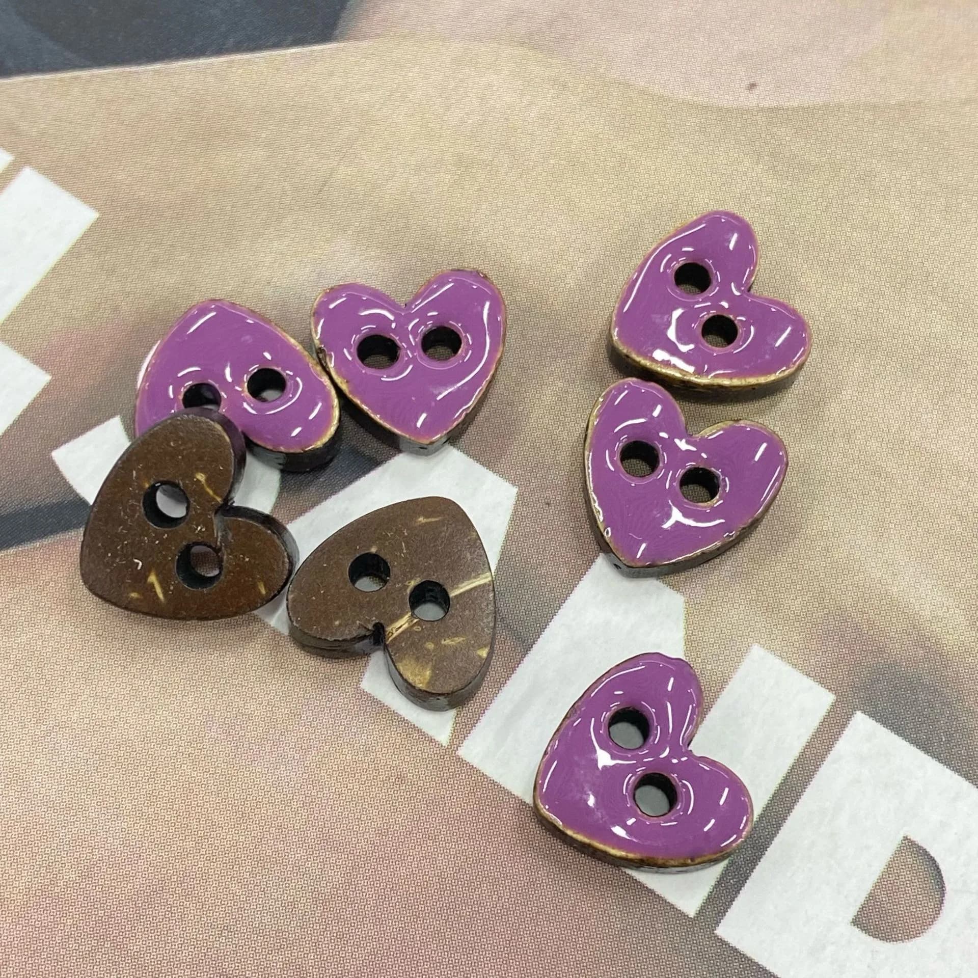 Purple coated heart-shaped coconut buttons with two holes